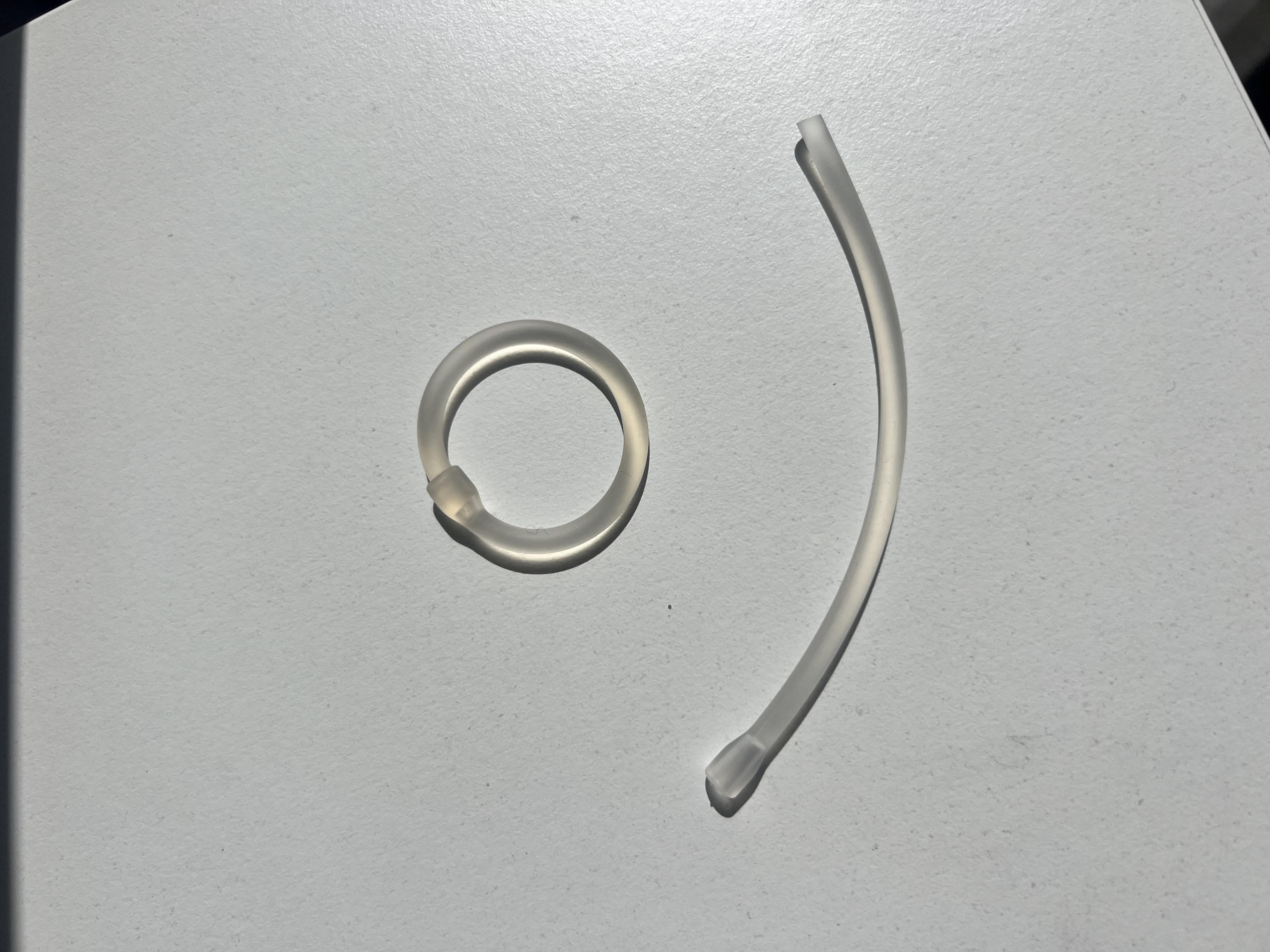 The Circunaro ring shown in circular form and as a flexible strip — a translucent medical-grade silicone device
